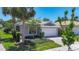 Charming single-story home with a two-car garage, well-manicured lawn, and lush landscaping at 15856 Cobble Mill Dr, Wimauma, FL 33598