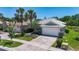 Attractive single-story home featuring a two-car garage, brick driveway, and neatly maintained landscaping at 15856 Cobble Mill Dr, Wimauma, FL 33598