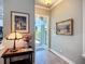 Elegant foyer with wood flooring, decorative lighting, and neutral wall colors at 15856 Cobble Mill Dr, Wimauma, FL 33598