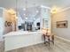 Bright kitchen featuring a center island with quartz countertop, stainless steel appliances, and stylish pendant lighting at 15856 Cobble Mill Dr, Wimauma, FL 33598