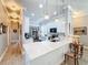 Bright kitchen featuring a center island with quartz countertop, stainless steel appliances, and stylish pendant lighting at 15856 Cobble Mill Dr, Wimauma, FL 33598