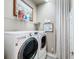 Laundry room with front load washer and dryer and plenty of storage space at 15856 Cobble Mill Dr, Wimauma, FL 33598
