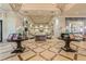 Beautiful lobby featuring two tables with flower arrangements and elegant seating areas at 15856 Cobble Mill Dr, Wimauma, FL 33598