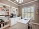Cozy office includes built-in shelving, sleek desk, and plenty of natural light at 15856 Cobble Mill Dr, Wimauma, FL 33598