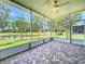 Screened porch with brick floor overlooking pond and lush landscaping at 15856 Cobble Mill Dr, Wimauma, FL 33598