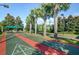 Fun shuffleboard courts lined with palm trees and seating areas for relaxation and socializing at 15856 Cobble Mill Dr, Wimauma, FL 33598