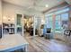 View from the sunroom into the living room and backyard with a beautiful chair at 15856 Cobble Mill Dr, Wimauma, FL 33598
