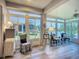 Light-filled sunroom with lake views, comfortable seating and ceiling fan at 15856 Cobble Mill Dr, Wimauma, FL 33598