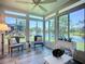 Sunroom with a ceiling fan and scenic views of the pond with fountain and beautiful yard at 15856 Cobble Mill Dr, Wimauma, FL 33598