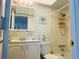 Clean, well-lit bathroom with tiled shower/tub and vanity storage at 400 Glennes Ln # 108, Dunedin, FL 34698