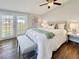 Bedroom features a queen bed, neutral decor, and sliding doors to the yard at 1214 Orange Ave, Dunedin, FL 34698