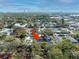 Aerial shot featuring the property nestled among lush trees with a view of the city skyline in the distance at 216 23Rd N Ave, St Petersburg, FL 33704