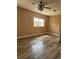 Bedroom features wood-look flooring, ceiling fan, and sunlit window at 3307 N Morgan St, Tampa, FL 33603