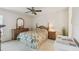 Comfortable bedroom with a decorative ceiling fan, neutral walls, and a large dresser at 4210 Revere Cir, New Port Richey, FL 34653