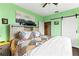 Bright bedroom showcases a ceiling fan, a large window, and a modern sliding barn door at 4802 51St W St # 224, Bradenton, FL 34210