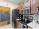 Traditional eat-in kitchen features stainless steel appliances and rustic brick backsplash at 4802 51St W St # 224, Bradenton, FL 34210