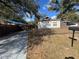 Charming home featuring a cozy front yard with a picket fence and a paved driveway at 8014 N Alaska St, Tampa, FL 33604