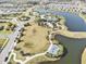 Aerial view of the community showcasing the pool, playground, lake, and neatly arranged homes at 8463 Canyon Creek Trl, Parrish, FL 34219