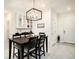 Bright dining area featuring a modern chandelier, wine rack, and seating for four at 8463 Canyon Creek Trl, Parrish, FL 34219