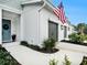 Well-maintained townhouse exterior featuring a light blue door and a two-car garage at 8463 Canyon Creek Trl, Parrish, FL 34219