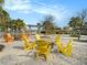 Cozy outdoor fire pit area with comfortable Adirondack chairs, ideal for gatherings and relaxation by the water at 8463 Canyon Creek Trl, Parrish, FL 34219