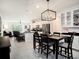 Open-concept kitchen and dining area with a modern chandelier and sleek finishes at 8463 Canyon Creek Trl, Parrish, FL 34219