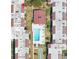 A bird's eye view shows a pool and tennis courts between low rise apartment buildings at 2060 Marilyn St # 133, Clearwater, FL 33765