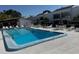 Community pool with a view of surrounding lounge chairs and community buildings at 2060 Marilyn St # 133, Clearwater, FL 33765