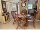 Cozy dining area features a glass top table, wicker chairs, and natural light at 2060 Marilyn St # 133, Clearwater, FL 33765