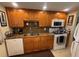 Spacious kitchen with wood cabinets, granite counters, and white appliances at 2060 Marilyn St # 133, Clearwater, FL 33765
