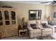 Relaxing living room with a cream loveseat, decorative mirror, and stylish furnishings at 2060 Marilyn St # 133, Clearwater, FL 33765