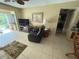 Bright living room with a recliner, sliding glass doors, and tile flooring at 2060 Marilyn St # 133, Clearwater, FL 33765