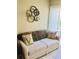 Comfortable living room featuring a sofa with throw pillows and natural light from the window at 2060 Marilyn St # 133, Clearwater, FL 33765