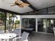 Enjoy this covered patio with ceiling fans, outdoor seating, and sliding glass doors to the interior at 2060 Marilyn St # 133, Clearwater, FL 33765