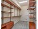 Walk-in closet featuring custom wooden shelving and drawers for optimal storage organization at 207 Winding River Trl, Bradenton, FL 34212