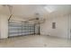 Spacious garage with painted walls, concrete floor and automatic door at 207 Winding River Trl, Bradenton, FL 34212