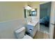 Bathroom featuring a sink, toilet, and doorway leading to bedroom at 2311 Brisbane St # 65, Clearwater, FL 33763