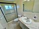 Bathroom featuring a glass shower, sink, and updated fixtures at 2311 Brisbane St # 65, Clearwater, FL 33763