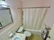 Bathroom featuring a shower/tub combo, sink, toilet, and updated lighting at 2311 Brisbane St # 65, Clearwater, FL 33763