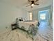 Bedroom featuring a ceiling fan, a full size bed, and white and gray marble flooring at 2311 Brisbane St # 65, Clearwater, FL 33763