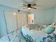 Bright bedroom features a ceiling fan, marble floor, and a spacious closet at 2311 Brisbane St # 65, Clearwater, FL 33763