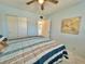 Bright bedroom features a ceiling fan, marble floor, and closet at 2311 Brisbane St # 65, Clearwater, FL 33763