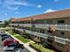 Multi-story condo building showing parking, decorative balconies and landscaping at 2311 Brisbane St # 65, Clearwater, FL 33763