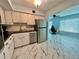 Bright kitchen with white cabinets, stainless appliances, marble floors, and view to office space at 2311 Brisbane St # 65, Clearwater, FL 33763