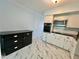 Kitchen with white appliances and cabinetry, black countertops, and marble tile flooring at 2311 Brisbane St # 65, Clearwater, FL 33763