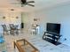 Open concept living room with piano, dining table and chairs at 2311 Brisbane St # 65, Clearwater, FL 33763