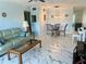 Open-concept living room featuring marble floors, comfortable seating, and dining area at 2311 Brisbane St # 65, Clearwater, FL 33763