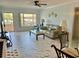 Living room and dining area featuring marble floors, view of balcony, and comfortable seating at 2311 Brisbane St # 65, Clearwater, FL 33763