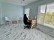Well-lit office area with marble tile flooring, bright windows, and neutral blue paint at 2311 Brisbane St # 65, Clearwater, FL 33763