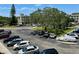View of the parking lot with mature trees and building at 2311 Brisbane St # 65, Clearwater, FL 33763